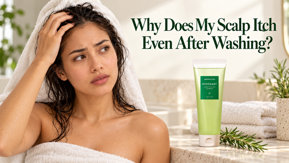 AROMATICA Rosemary Scalp Scaling Shampoo tube beside rosemary sprigs and a folded towel.